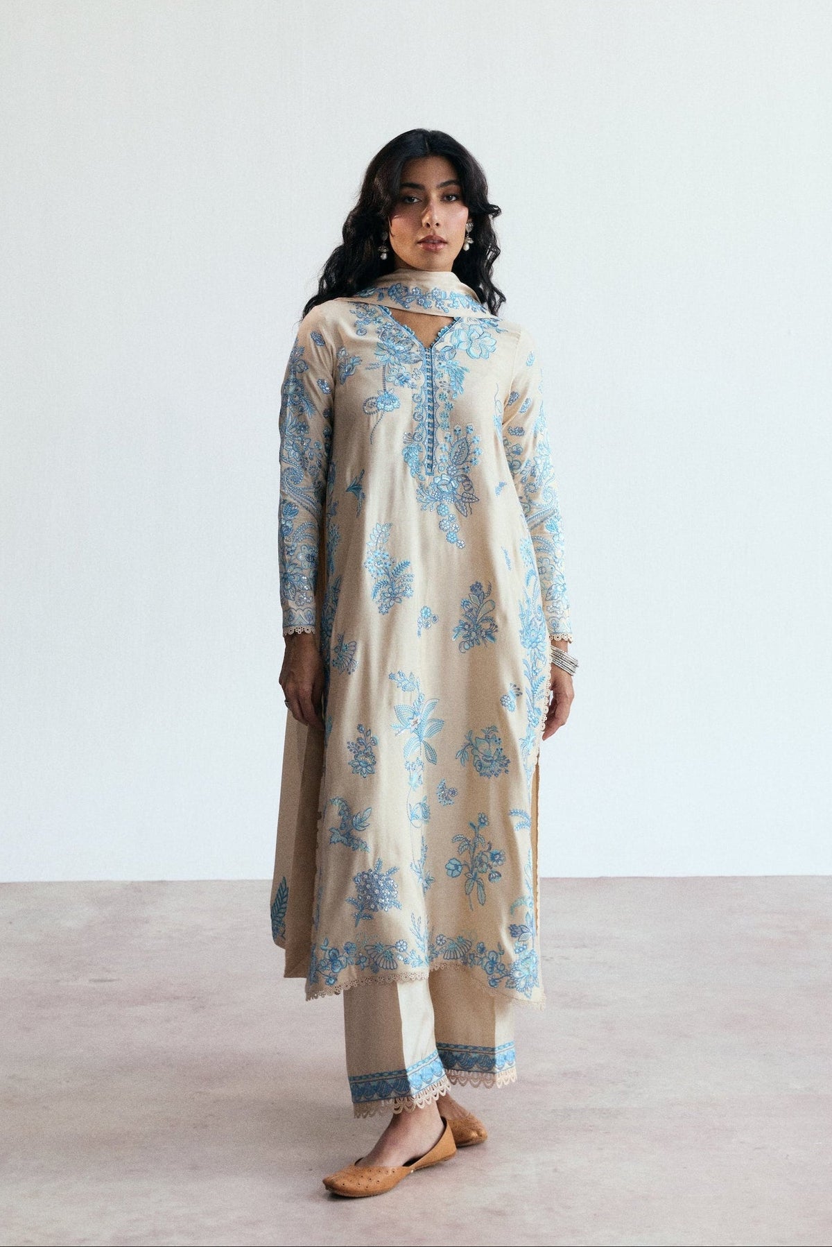 Close-up of the Opalite Set showing blue floral threadwork and scalloped lace detailing on the sleeves.