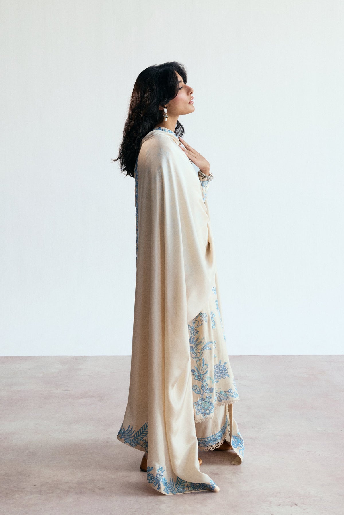 Model wearing the Opalite Set formal cream and blue embroidered three-piece Pakistani suit.