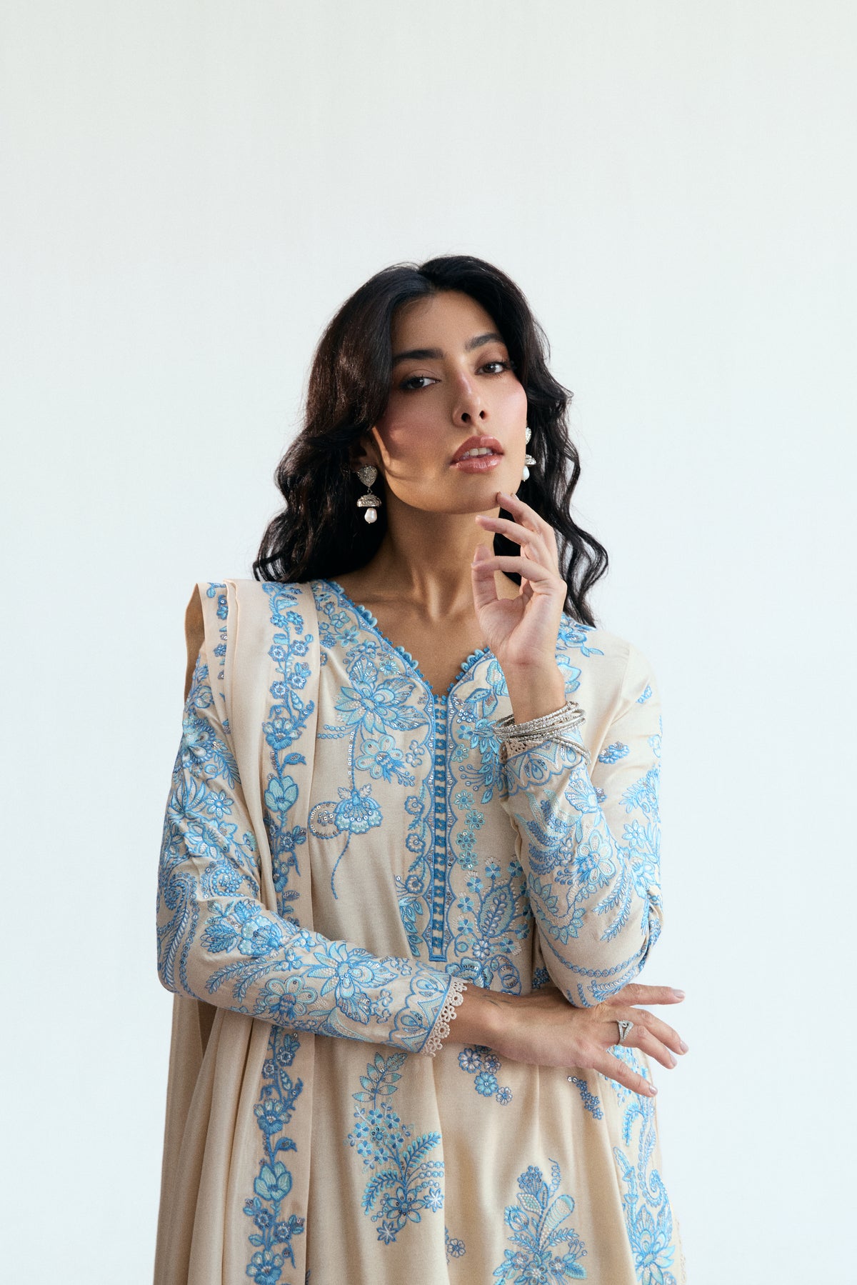 Close-up of Opalite Set soft cream rayon fabric with delicate blue threadwork and subtle sequin detailing.