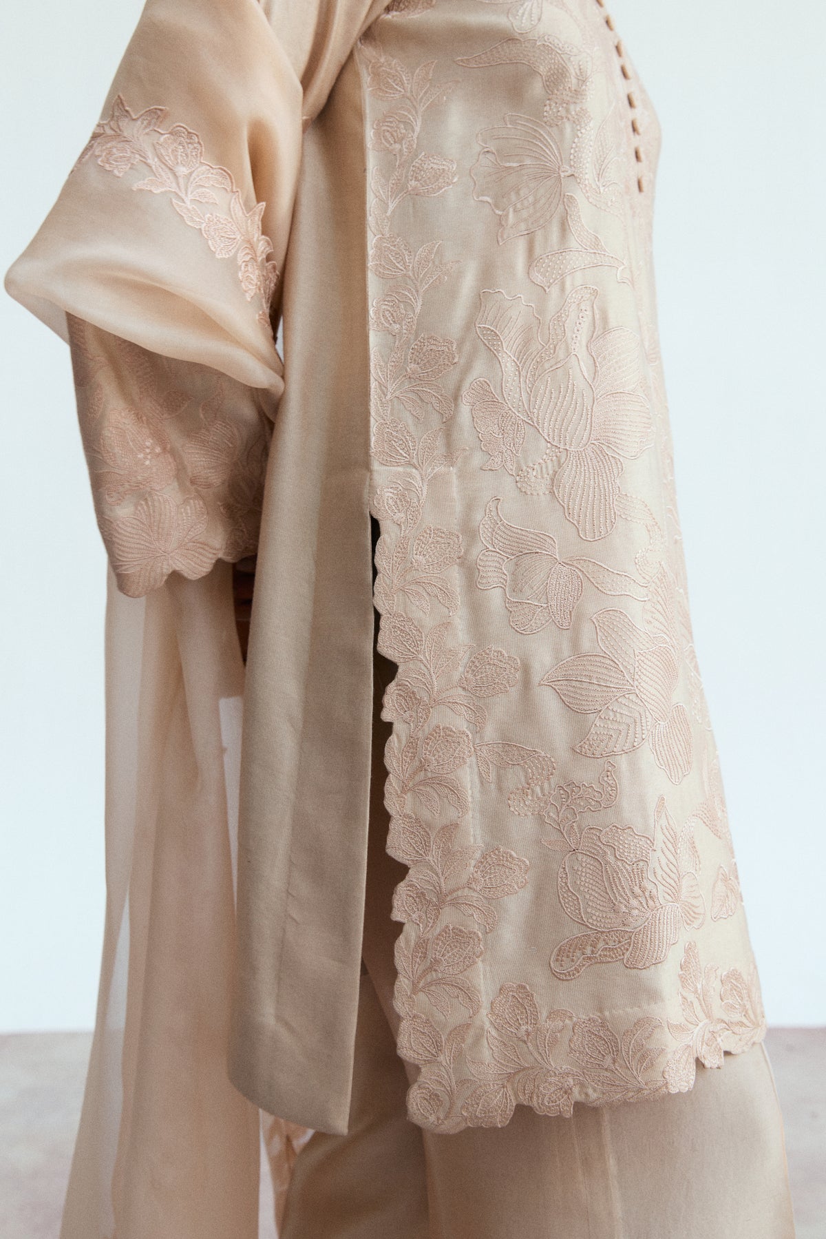 Close-up of embroidered organza kameez side border with intricate cutwork finish