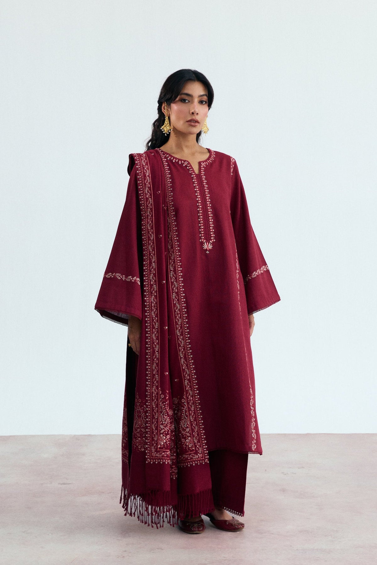 Mannam Garnet Set — deep red khaddar kameez with Kashmiri embroidery on panel seams, straight trousers and tassel shawl, Pakistani winter suit UK