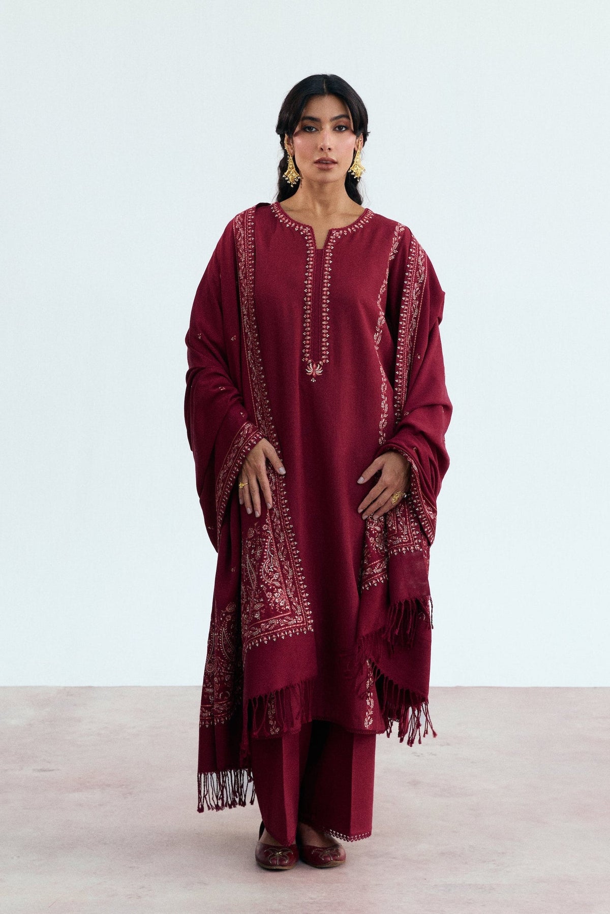 Women wearing Mannam Garnet deep red khaddar Pakistani suit with Kashmiri embroidery and viscose shawl