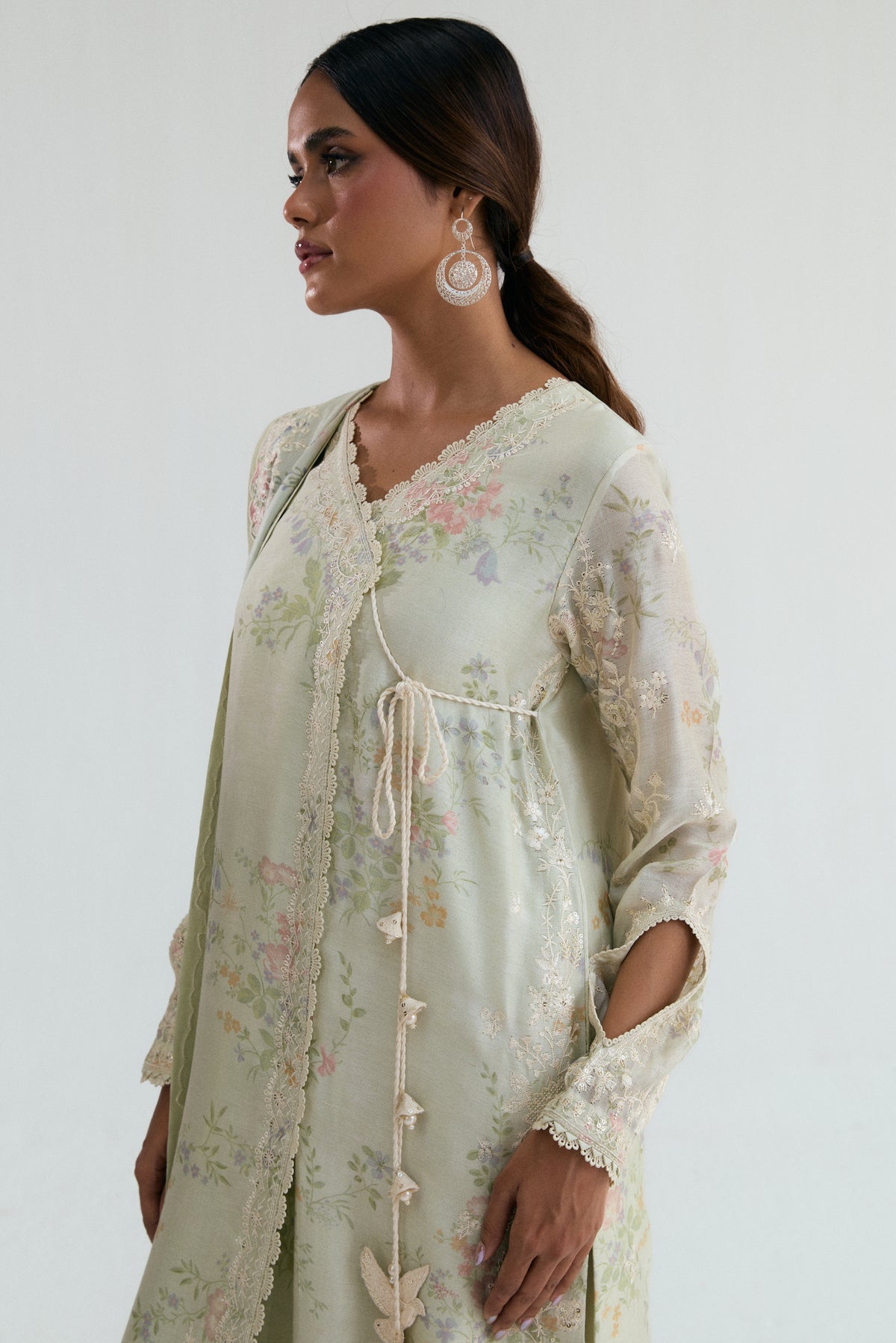 Lightweight khadi net angrakha in soft green-beige with lace trim and fabric-edged detailing, side view