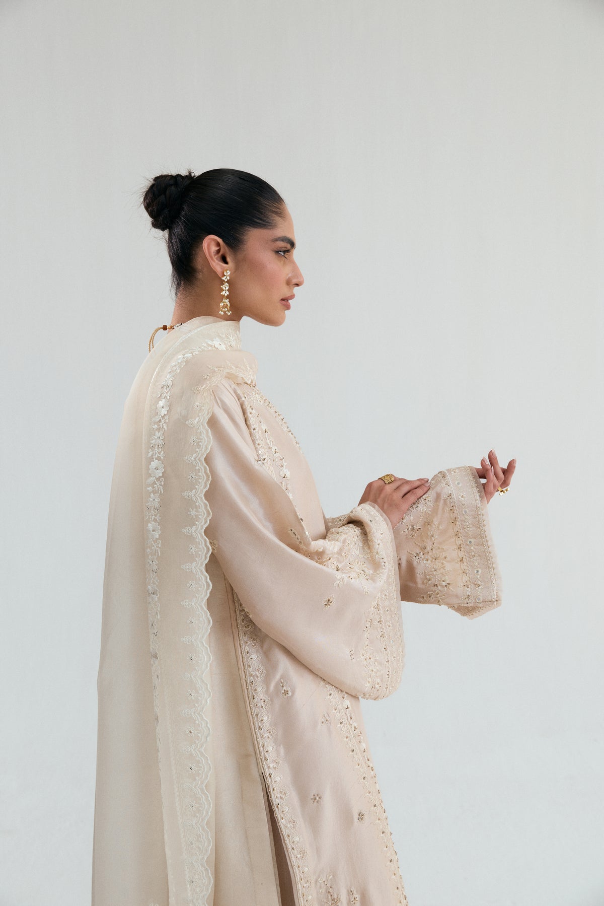 Detail shot of scalloped edge pure organza dupatta with floral multihead embroidery in honey gold tones