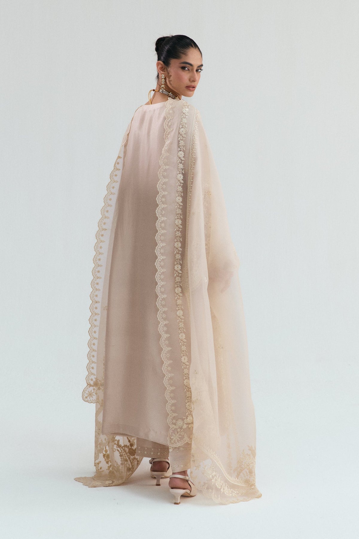 Full-length view of luxury silk Pakistani 3-piece suit with embroidered hem trousers and flowing dupatta