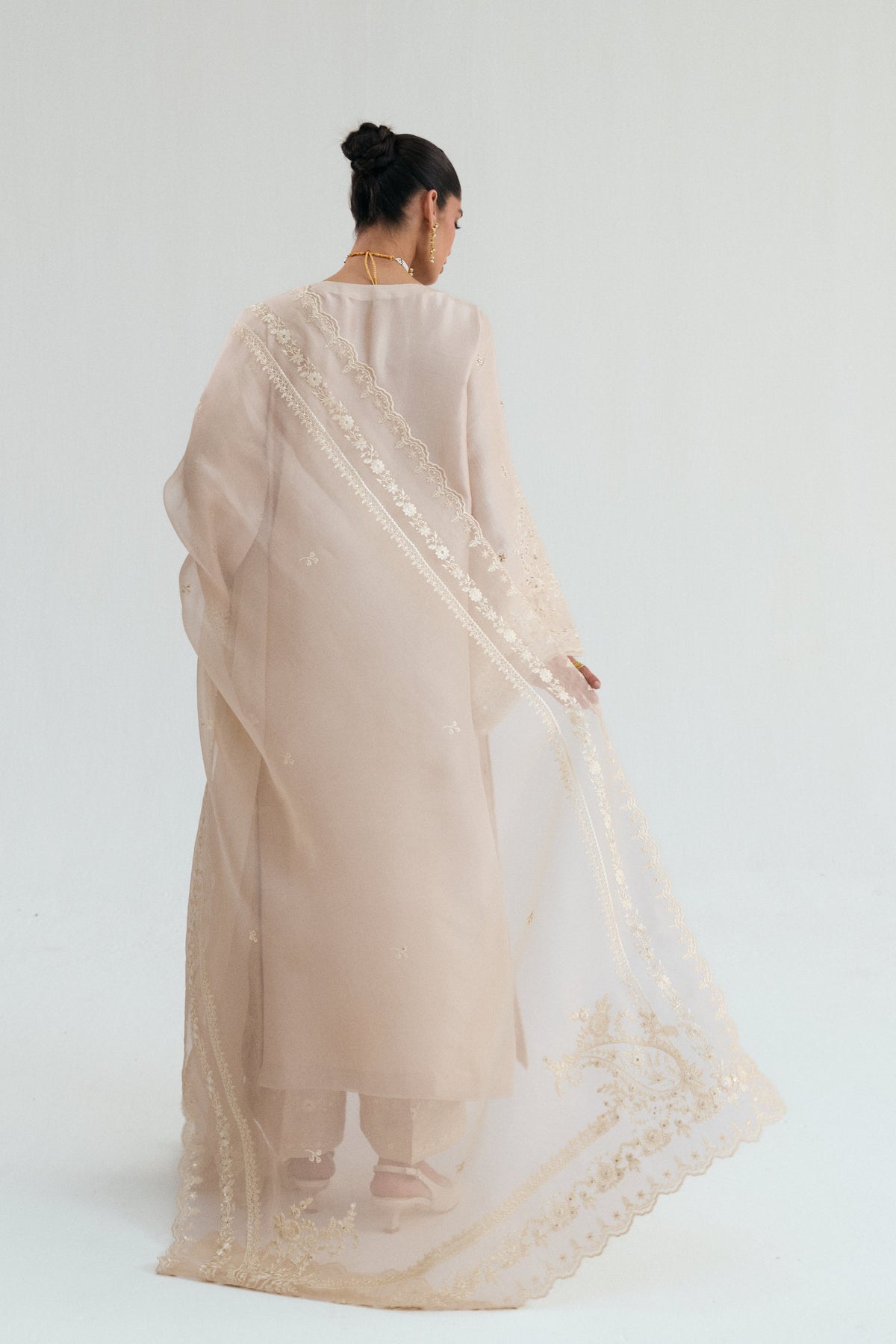 Back view of embellished silk suit with mirror and hand embroidery detailing.