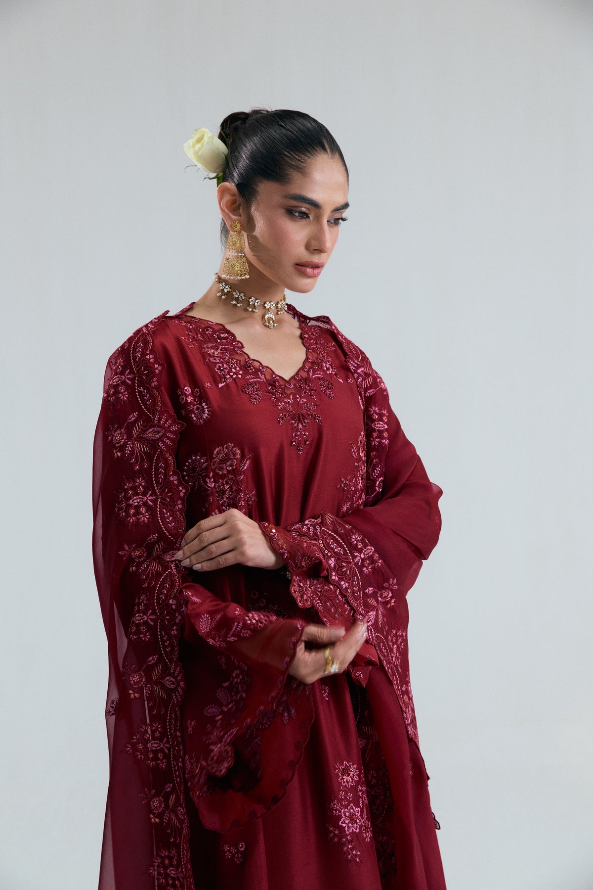 Back view of maroon raw silk Pakistani kameez with floral threadwork and organza neckline finishings by Mannam