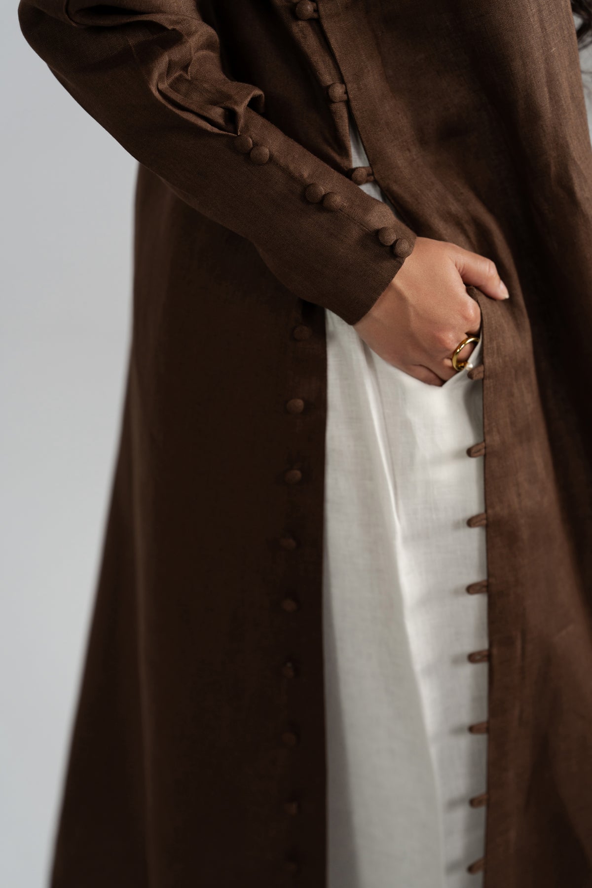 Loop button detailing along the side seam of Mocha Set kameez, front slit revealing contrast white shalwar having side pockets