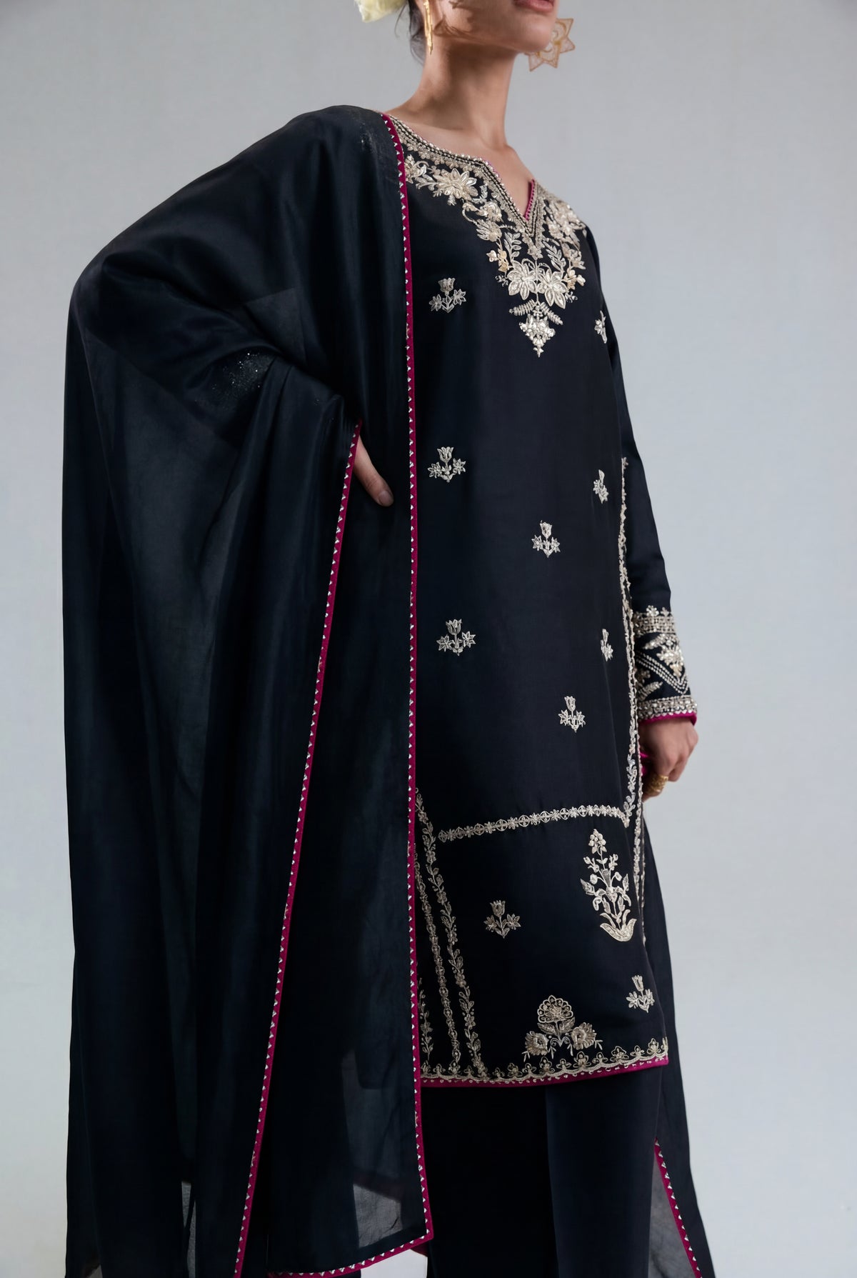 A black scarf with many colors and shiny threadwork that completes the Starlight Set.