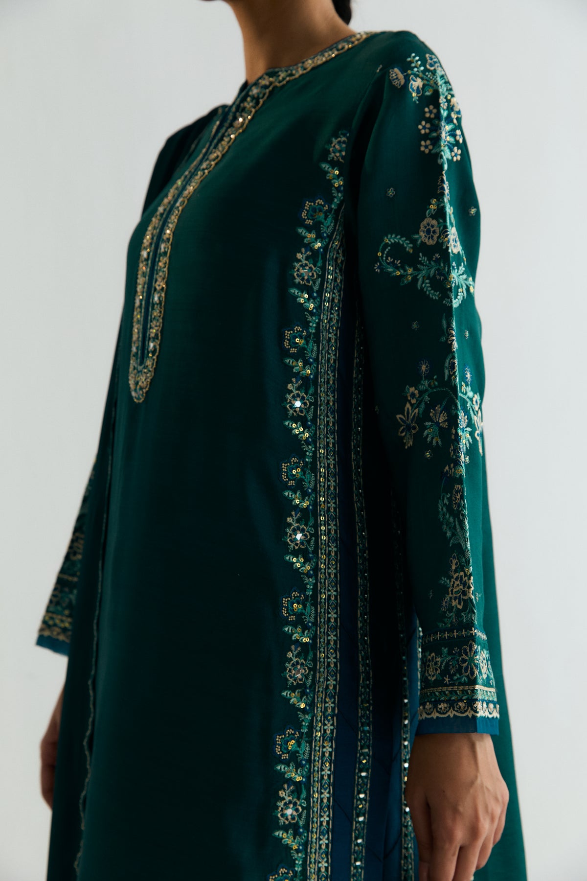 Formal Pakistani teal khaadi silk dress with mirror work embroidery and sleek tailored raw silk trousers