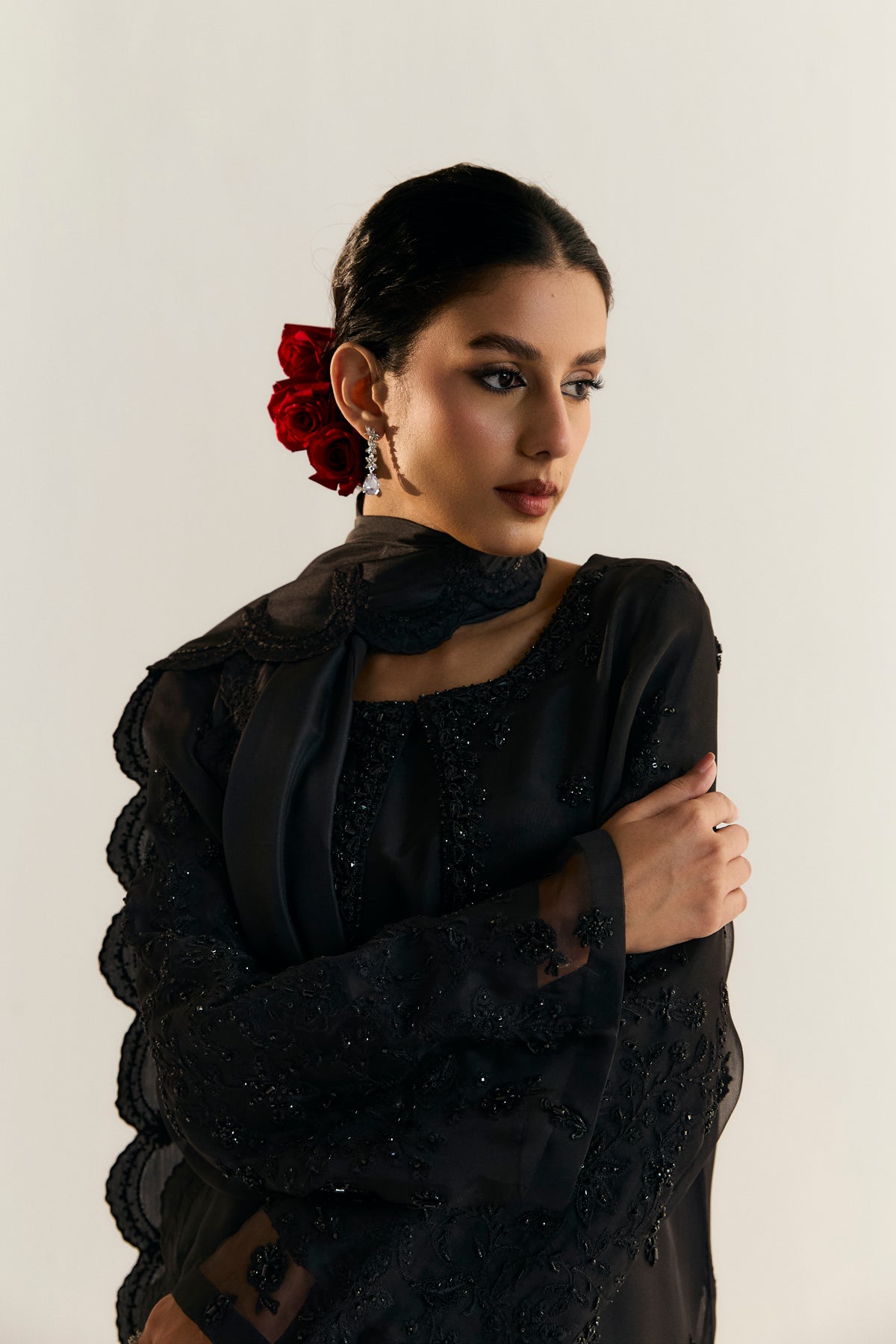 High-end black Pakistani organza formal suit with raw silk culotte trousers and hand-embroidered petal-edge dupatta