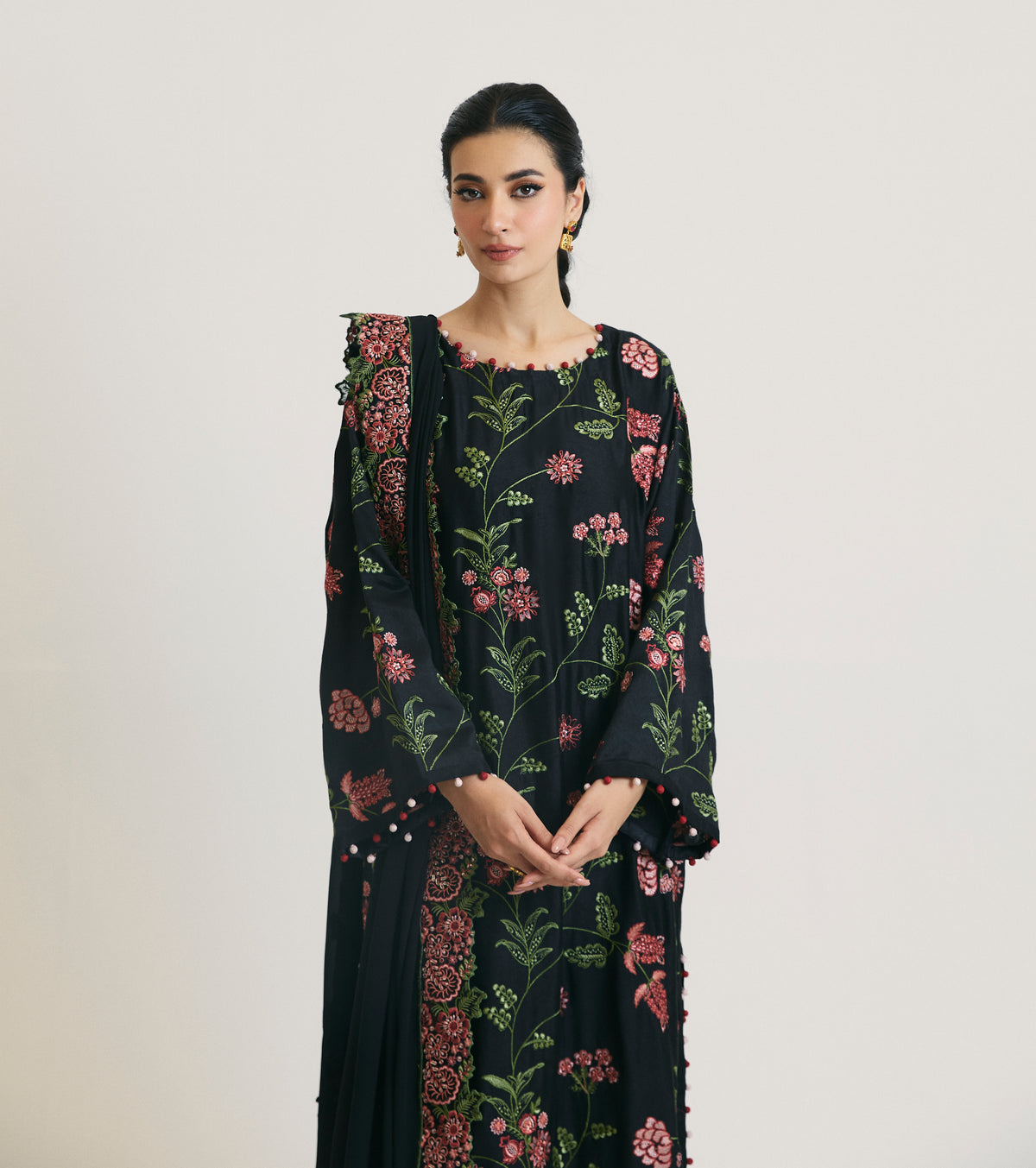 Full-length view of black Pakistani rayon salwar kameez with bobble-trim hem — modern embroidered formal wear UK