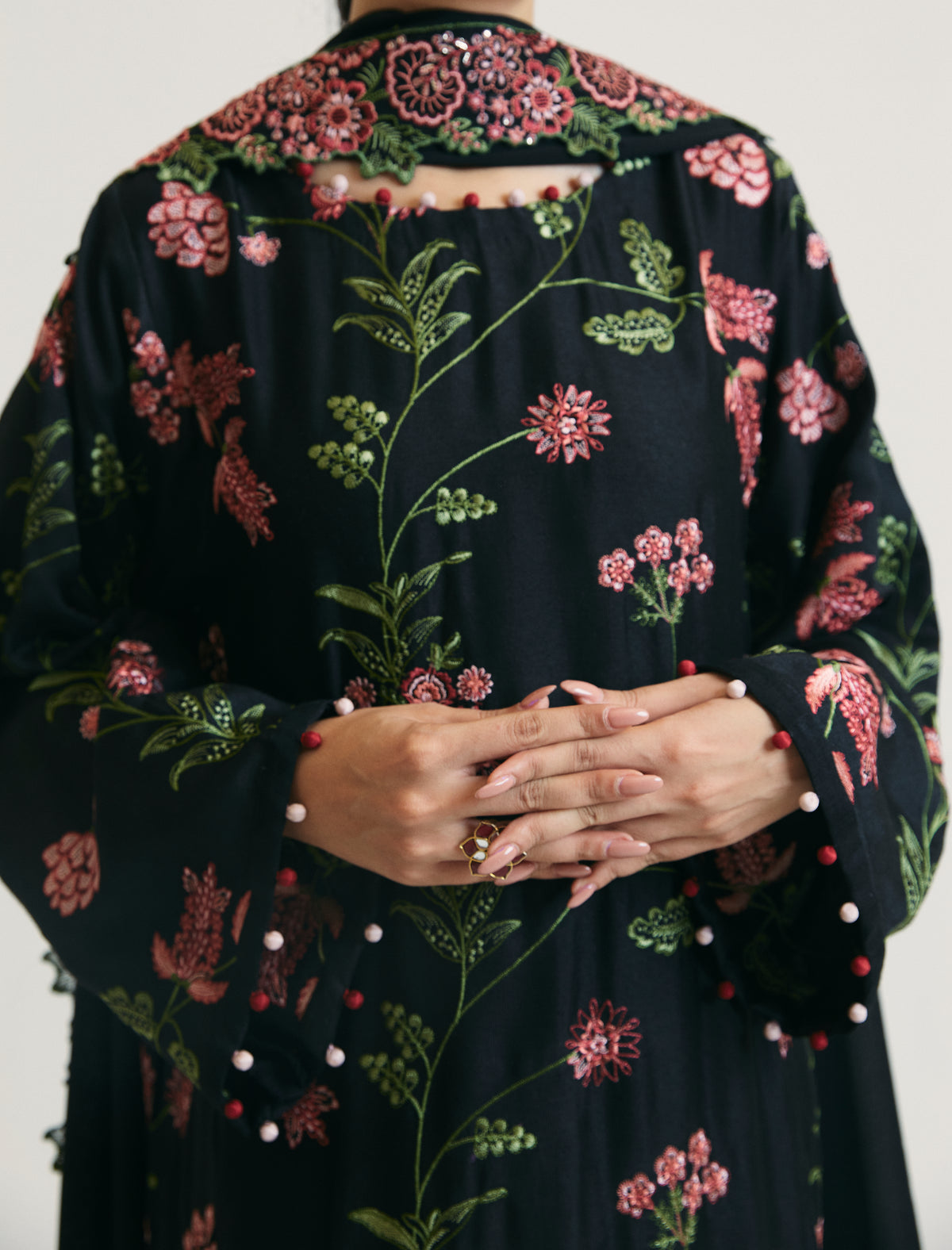 Women wearing Mannam black embroidered rayon kameez set with silk trousers — designer Pakistani ethnic wear