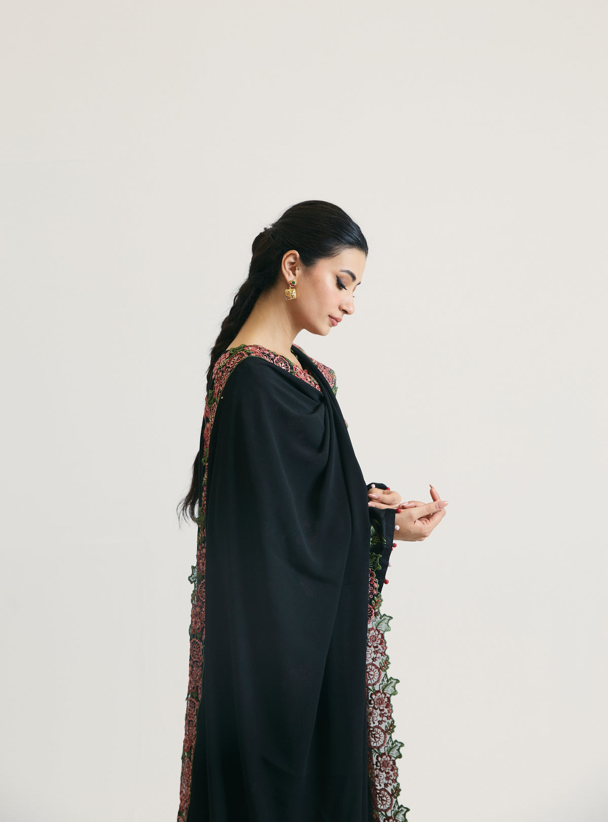 Side view of black embroidered rayon Pakistani kameez with dupatta — luxury ethnic formal wear for women by Mannam