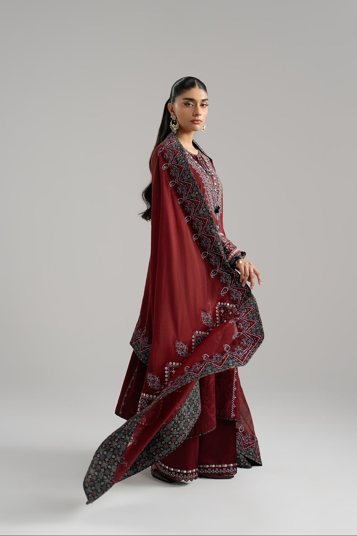Deep maroon dupatta detail — scalloped embroidery and ajrak print | Mannam Saffron Set Pakistan