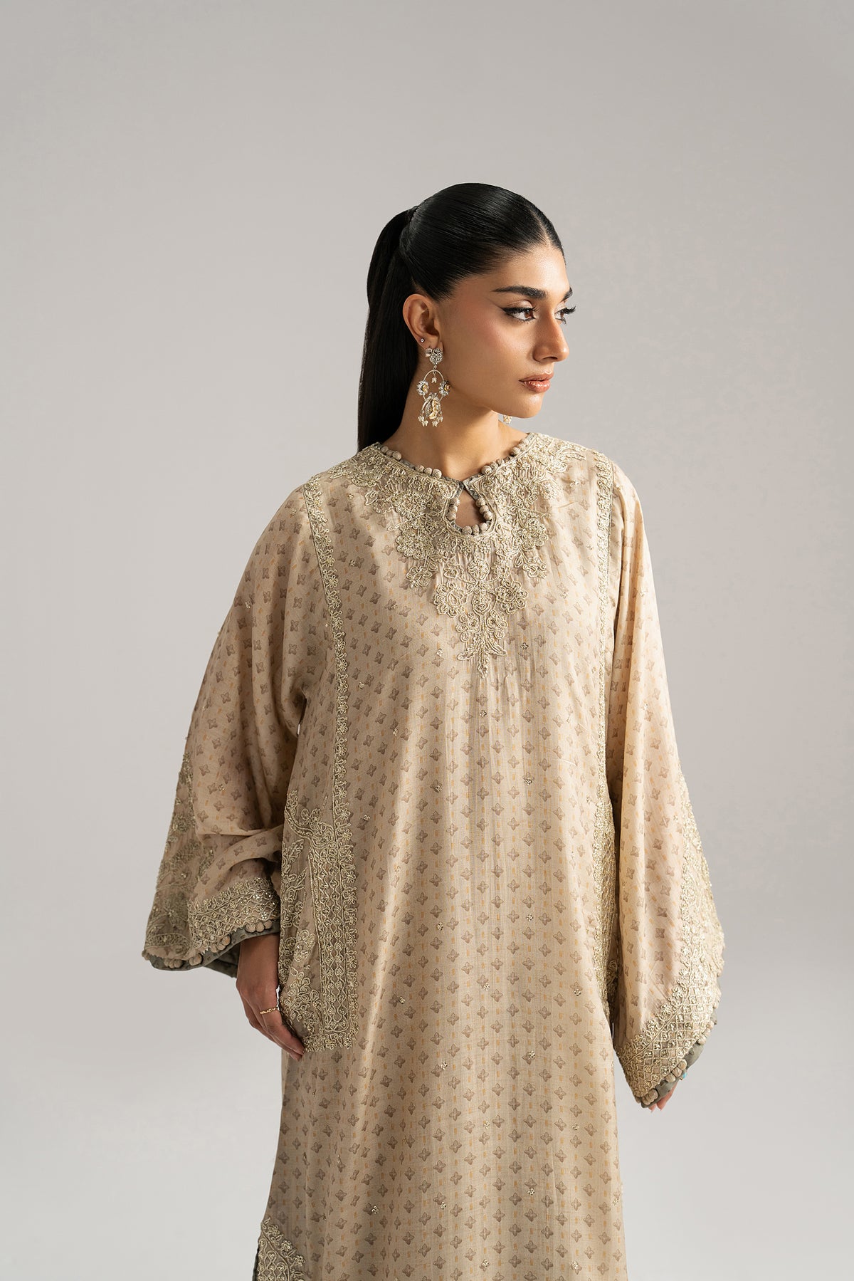 Taupe Set shalwar detail — contrast silk printed shalwar with tilla dori and goti lace at hem