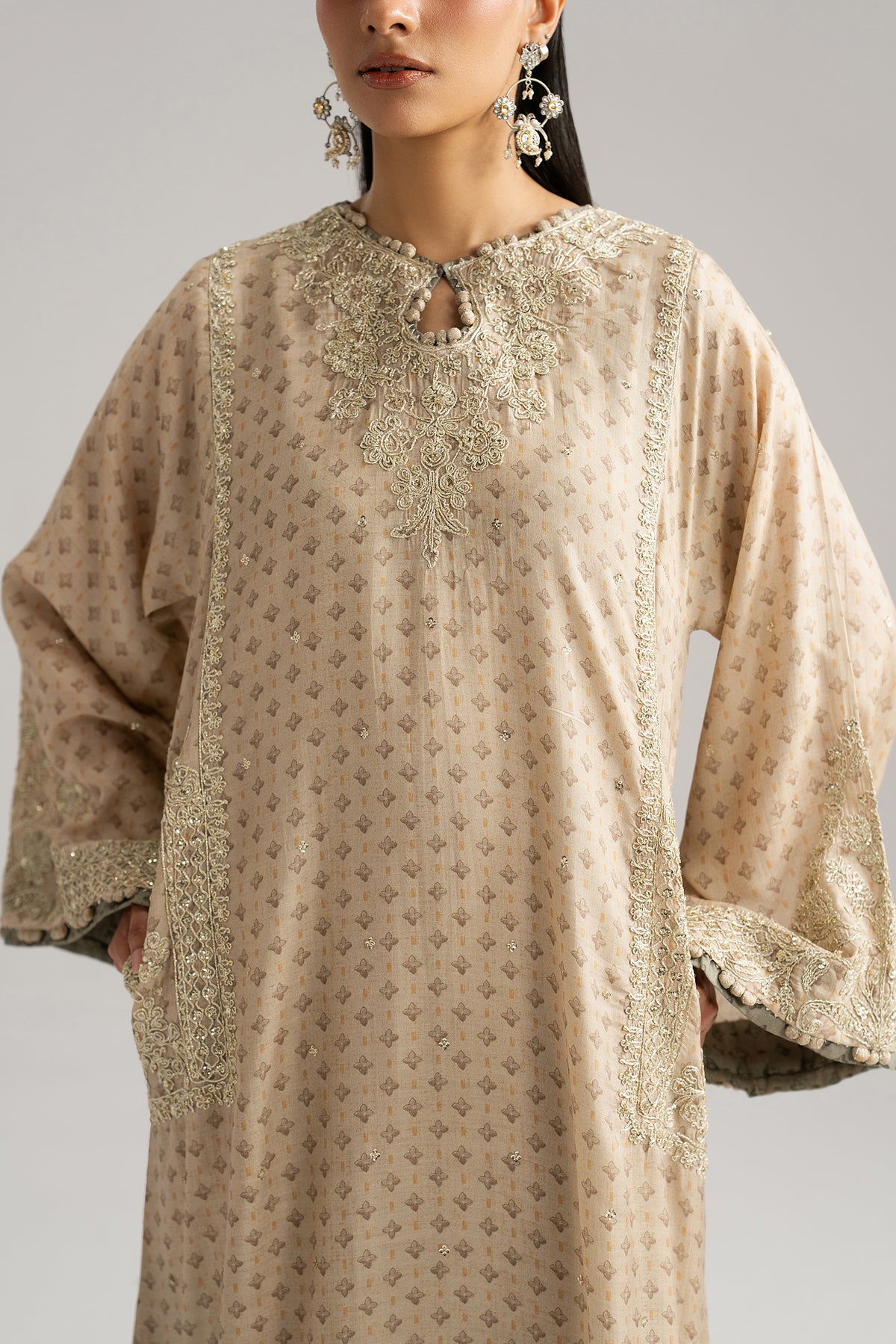 Soft ivory silk phiran with Hyderabadi tilla dori embroidery — sequin neckline and goti lace | Mannam Pakistani Eid