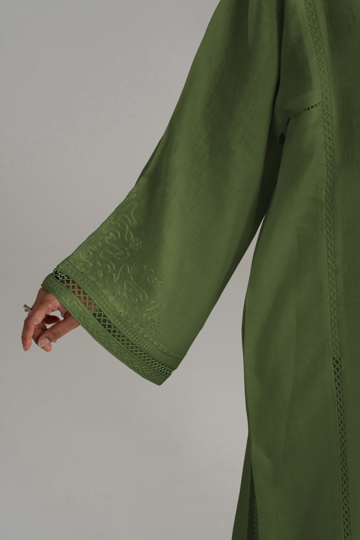 Close-up of the Clover Set's wide bell sleeve and cuff in green linen