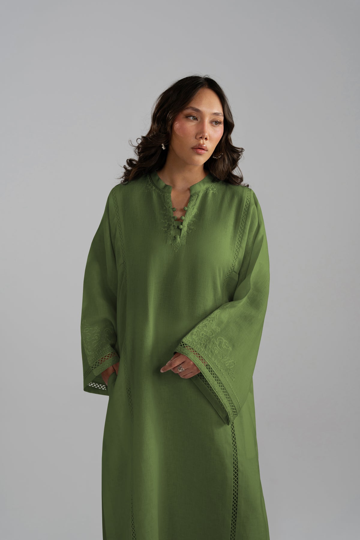 Three-quarter front view of the Clover Set in green linen with wide-hem trousers