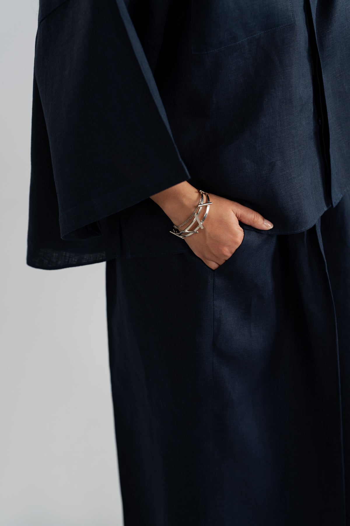 Wide sleeve cuff and hand in trouser pocket