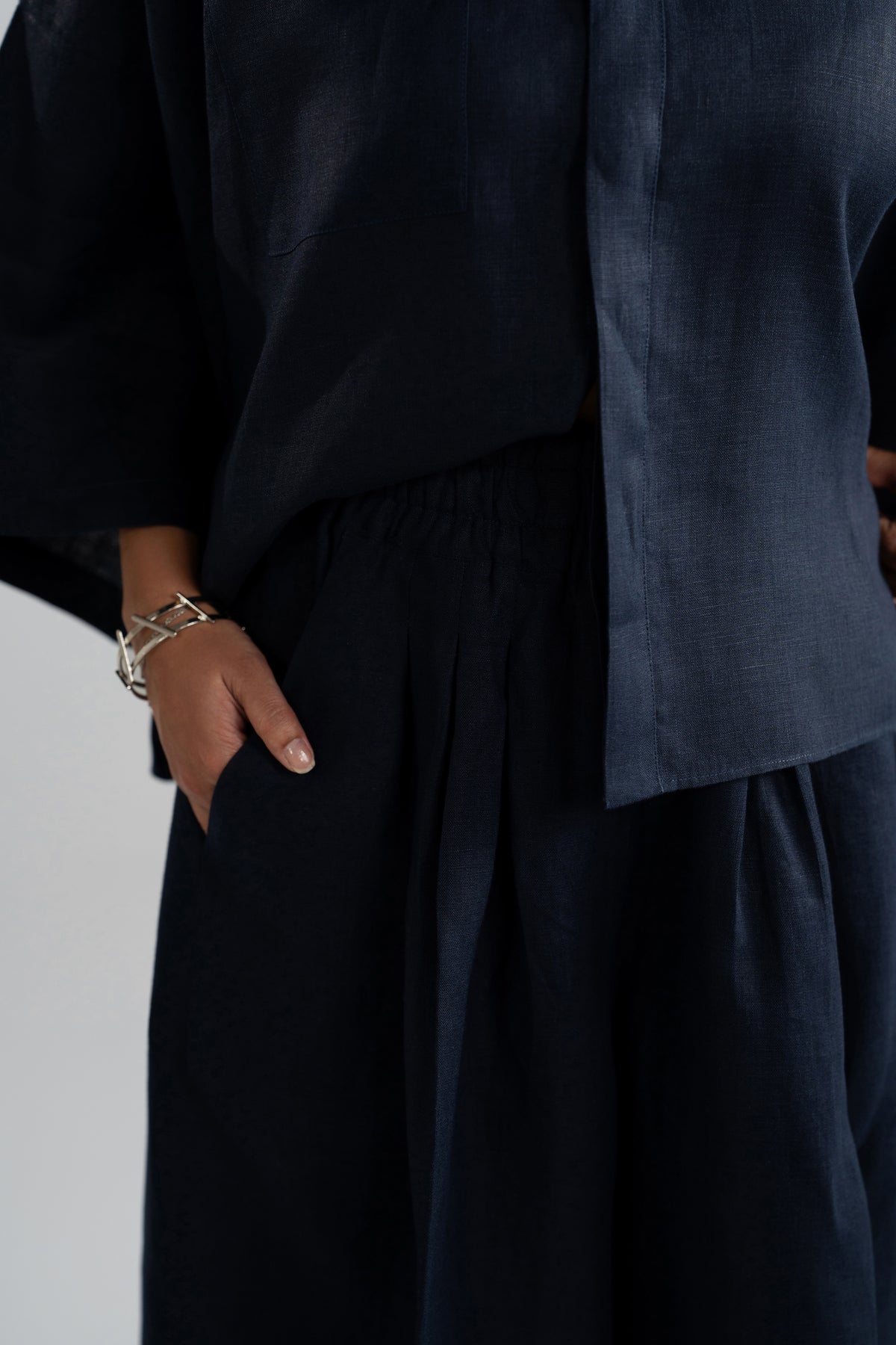 Side pocket detail on Indigo Set high-waisted wide-leg trousers