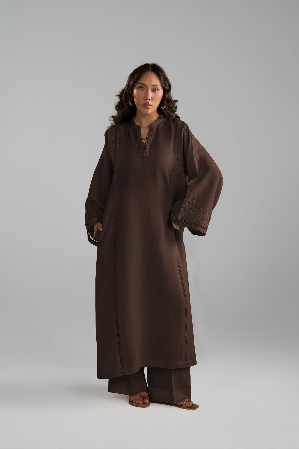 Maple Set in brown worn as a long-sleeve tunic with wide-hem trousers, styled with tan sandals
