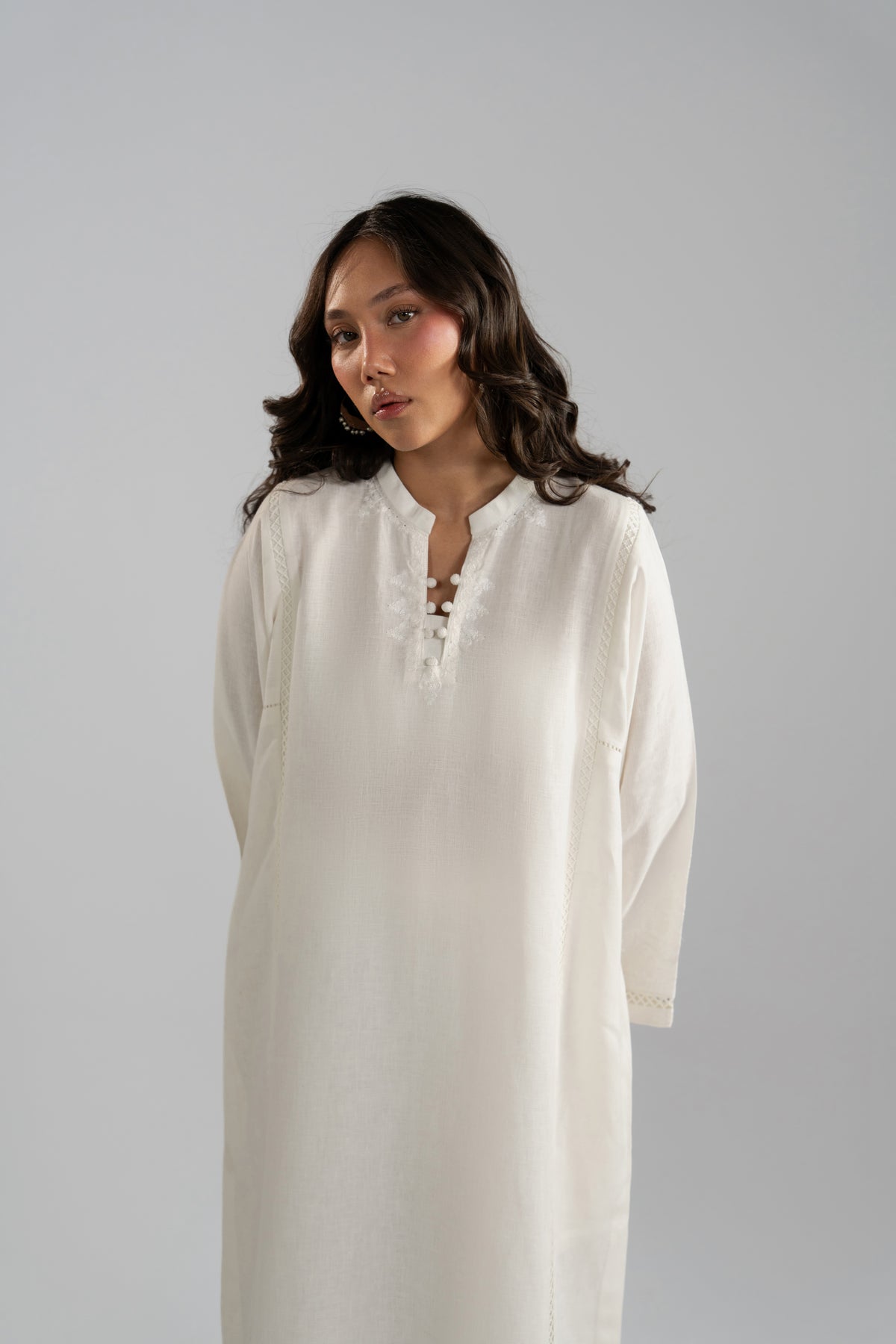 Close-up of Noor Set button neckline and embroidery detail
