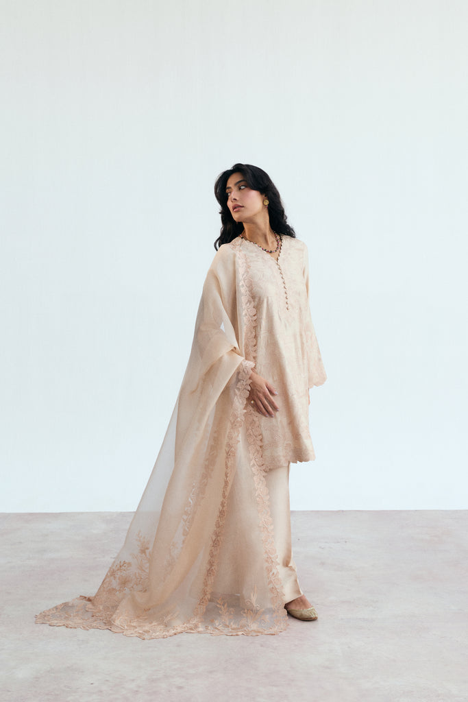 Soft peachy pink Pakistani embroidered ensemble with floral cutwork and raw silk trousers, timeless pastel party wear for women