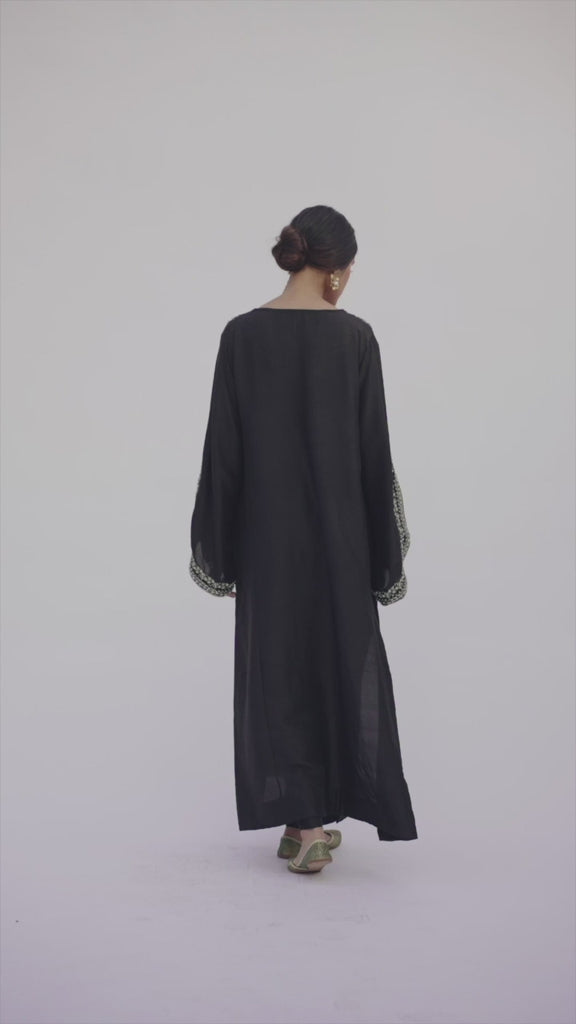 Video of Mannam Black Phiran Set — black raw silk Pakistani phiran with hand-embroidered V-neckline and raw silk trousers