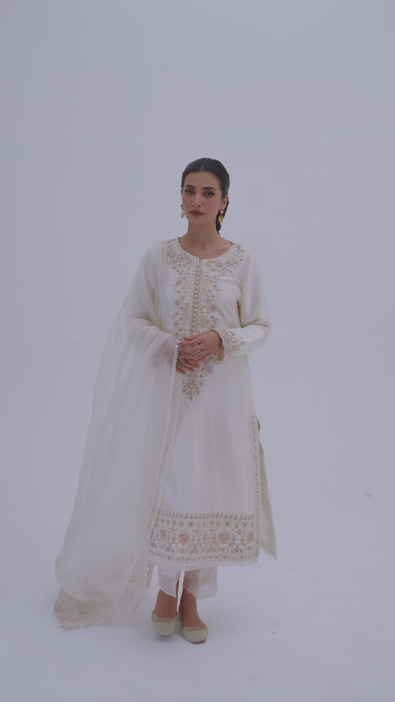 Video demonstration of the ivory raw silk kameez suit with floral embroidery details, draped organza dupatta, and overall fit worn by a model.