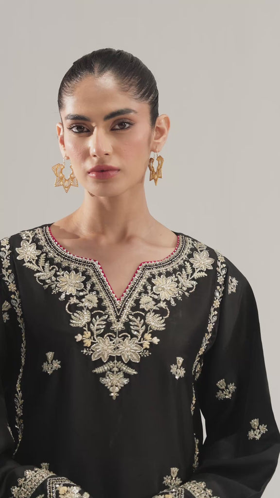 The bottom edge of the Starlight Set shirt featuring pink trim and fancy scalloped lace.
